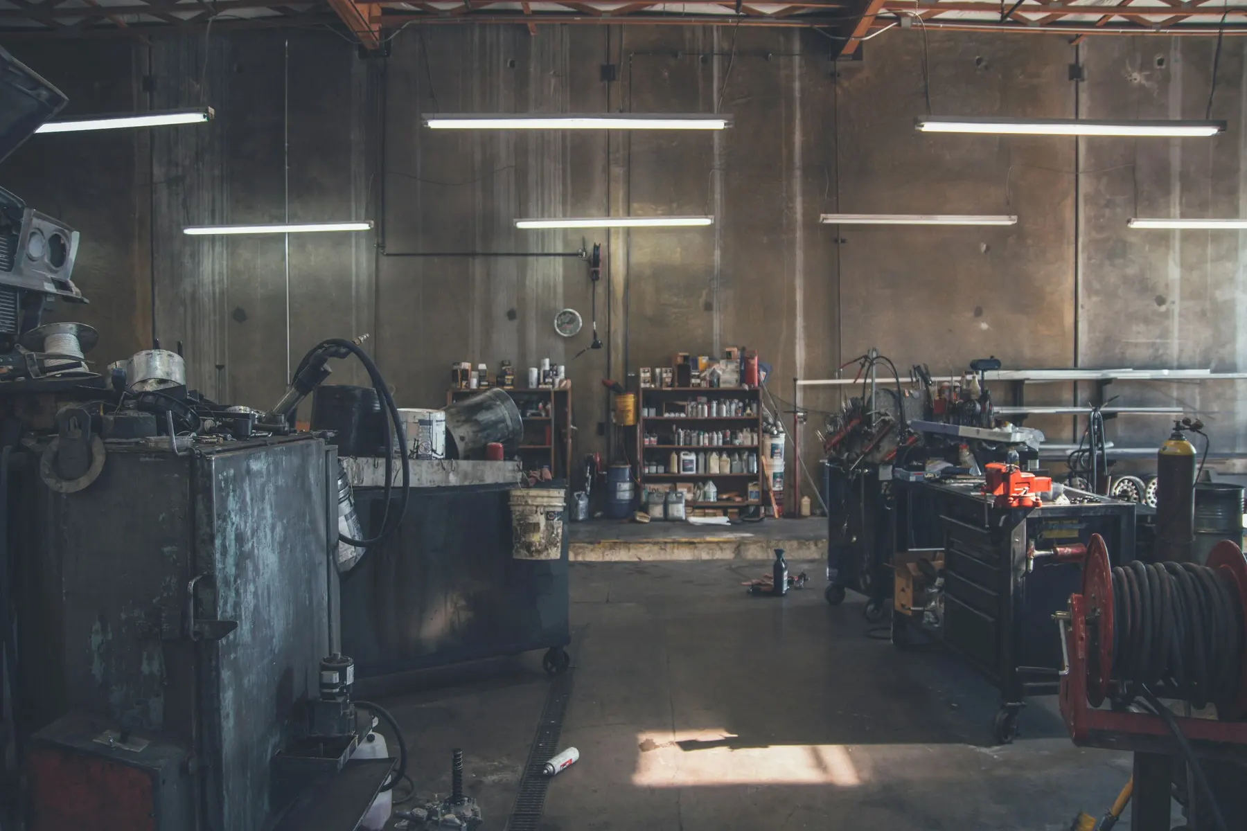 A workshop bay at the end of the day, tool chests lined up under low light